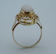 An unmarked gold and opal ring. Ring size M/N.