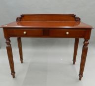 A modern mahogany two drawer side table, formerly purchased from Harrod's. 121 cm wide.