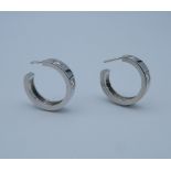 A pair of 18 ct white gold and diamond hoop earrings.