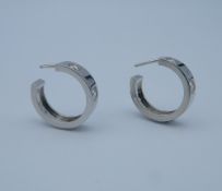 A pair of 18 ct white gold and diamond hoop earrings.