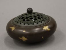 A Chinese gold splash bronze censer. 11.5 cm diameter.