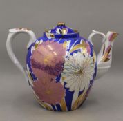 A large decorative gilt heightened porcelain tea pot. 24 cm high.