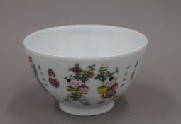 A Chinese porcelain bowl painted in bright enamels with boys in various pursuits,