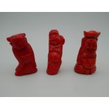 Three carved coral figures. The largest 6.5 cm high.