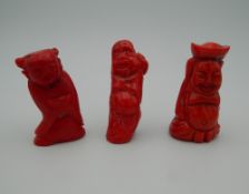 Three carved coral figures. The largest 6.5 cm high.