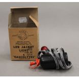 A 1944 boxed life jacket light.