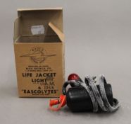 A 1944 boxed life jacket light.