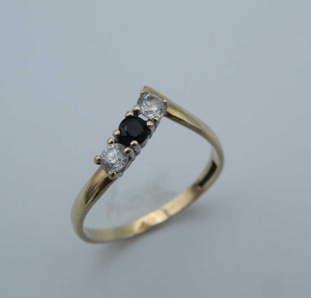 A 9 ct gold diamond and sapphire wishbone ring. Ring size M (1.