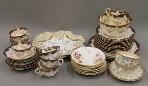 A quantity of gilt heightened porcelain tea wares, including Spode.