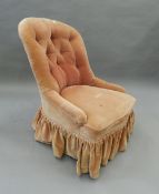 A 19th century Gillows ebony and parcel gilt framed button back nursing chair. 58 cm wide.