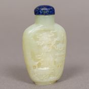 A small Chinese carved jade snuff bottle Of flattened form, with lapis lazuli stopper,