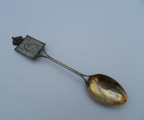 An Edward VII Coronation spoon inset with a stamp. 13 cm long (13 grammes total weight).