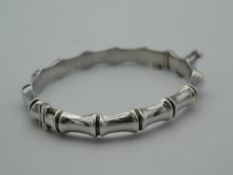 A silver faux bamboo bracelet. 7 cm wide.