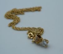 A 1/4 carat diamond solitaire pendant on a 9 ct gold chain (2.