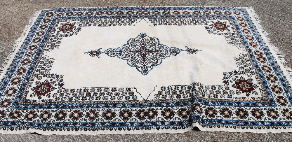 A Moroccan white ground rug. 183 cm wide.