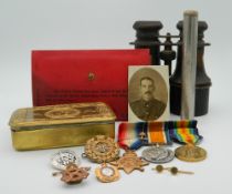 A set of WWI medals, badges, bayonet, a Princess Mary 1914 Christmas tin, paperwork, etc.