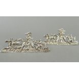 A pair of silver menu holders depicting hunting scenes. 8.5 cm long, 3.5 cm high. (34.