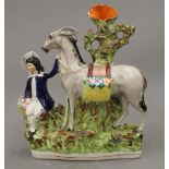 A 19th century Staffordshire figure of a boy and his donkey. 24 cm high.