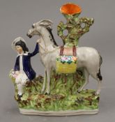 A 19th century Staffordshire figure of a boy and his donkey. 24 cm high.