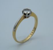 An 18 ct gold and platinum diamond solitaire ring. Ring size J (1.