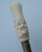 A bone carved walking stick formed as a Shou Lao. 89 cm long.