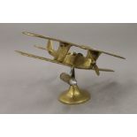 A brass model of a bi-plane. 27 cm wide.