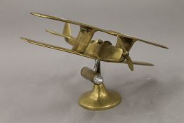 A brass model of a bi-plane. 27 cm wide.