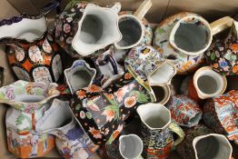 A collection of Masons and other Ironstone jugs, various sizes.