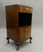 A walnut bow fronted pot cupboard. 75 cm high.