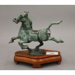 After the Antique, patinated bronze horse on wooden stand. 18 cm long.