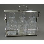 A Victorian three bottled silver plated tantalus, makers mark to base. 36 cm wide.