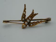 A Victorian gold and seed pearl swallow brooch. 3.5 cm wide (1.