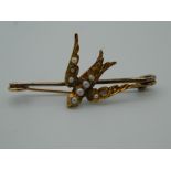 A Victorian gold and seed pearl swallow brooch. 3.5 cm wide (1.