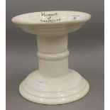 A white porcelain ham stand, inscribed ''Herbert's of Smithfield''. 19 cm high.