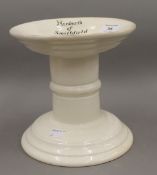 A white porcelain ham stand, inscribed ''Herbert's of Smithfield''. 19 cm high.