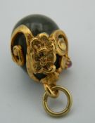 A silver gilt mounted egg form pendant. 2 cm high.