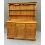 A modern pine dresser, a modern pine table and a set of six modern pine chairs.