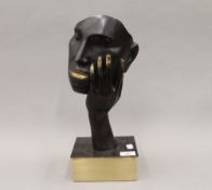 A bronze model of an abstract face. 39 cm high.