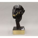 A bronze model of an abstract face. 39 cm high.