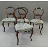 A set of four Victorian rosewood balloon back dining chairs. 45 cm wide.