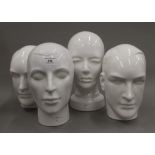 Four white porcelain busts. The largest 29 cm high.