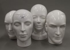 Four white porcelain busts. The largest 29 cm high.