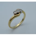 An 18 ct gold three diamond trilogy ring. Ring size L/M (3.