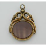 A Victorian spinning fob set with carnelian and bloodstone. 2.5 cm wide.