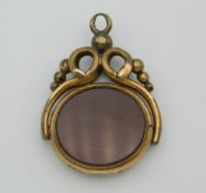 A Victorian spinning fob set with carnelian and bloodstone. 2.5 cm wide.