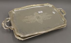 Two silver plated trays. The largest 53 cm wide.