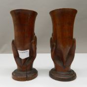 A pair of carved treen souvenirs from Pitcairn vases. Each 17 cm high.