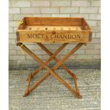 A wooden butlers tray on stand.