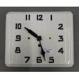 An Art Deco white porcelain wall clock. 24.5 cm wide.