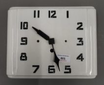 An Art Deco white porcelain wall clock. 24.5 cm wide.